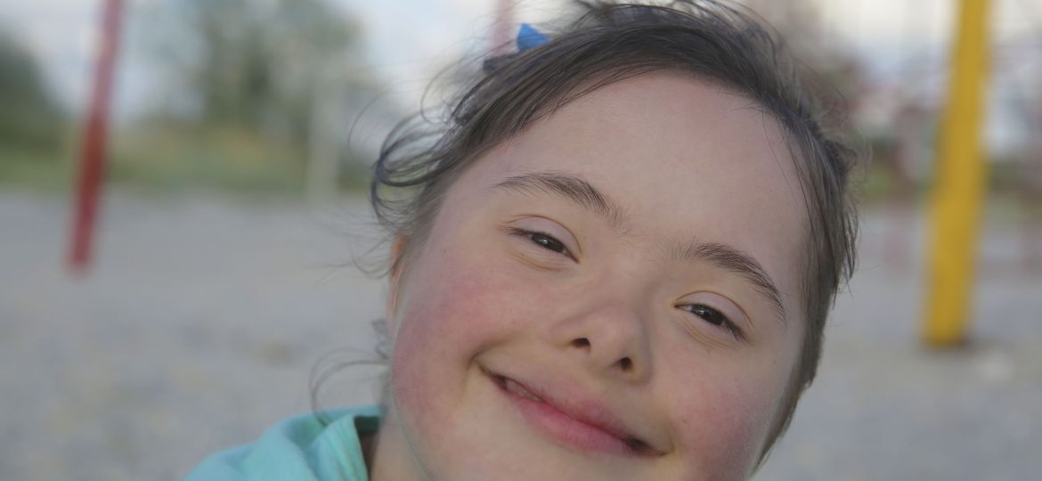 Portrait of down syndrome girl smiling