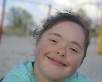 Portrait of down syndrome girl smiling