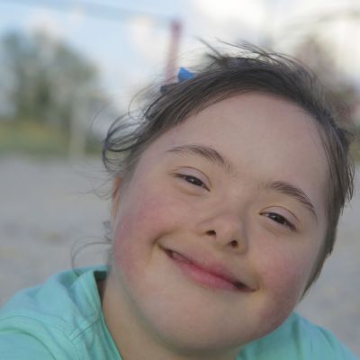 Portrait of down syndrome girl smiling