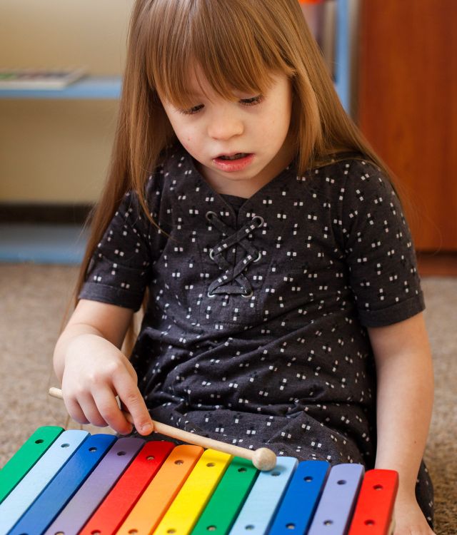 girl-with-down-syndrome-playing-with-xylophone