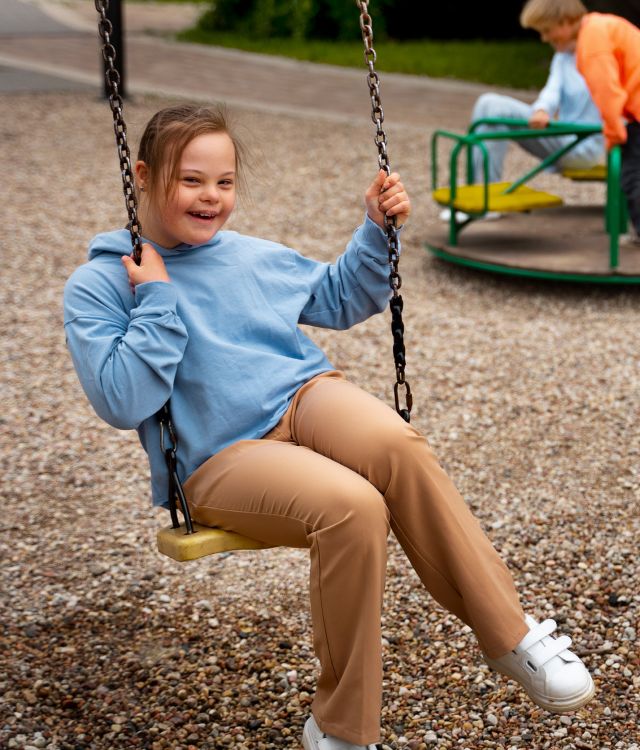 side-view-girl-with-down-syndrome-swing